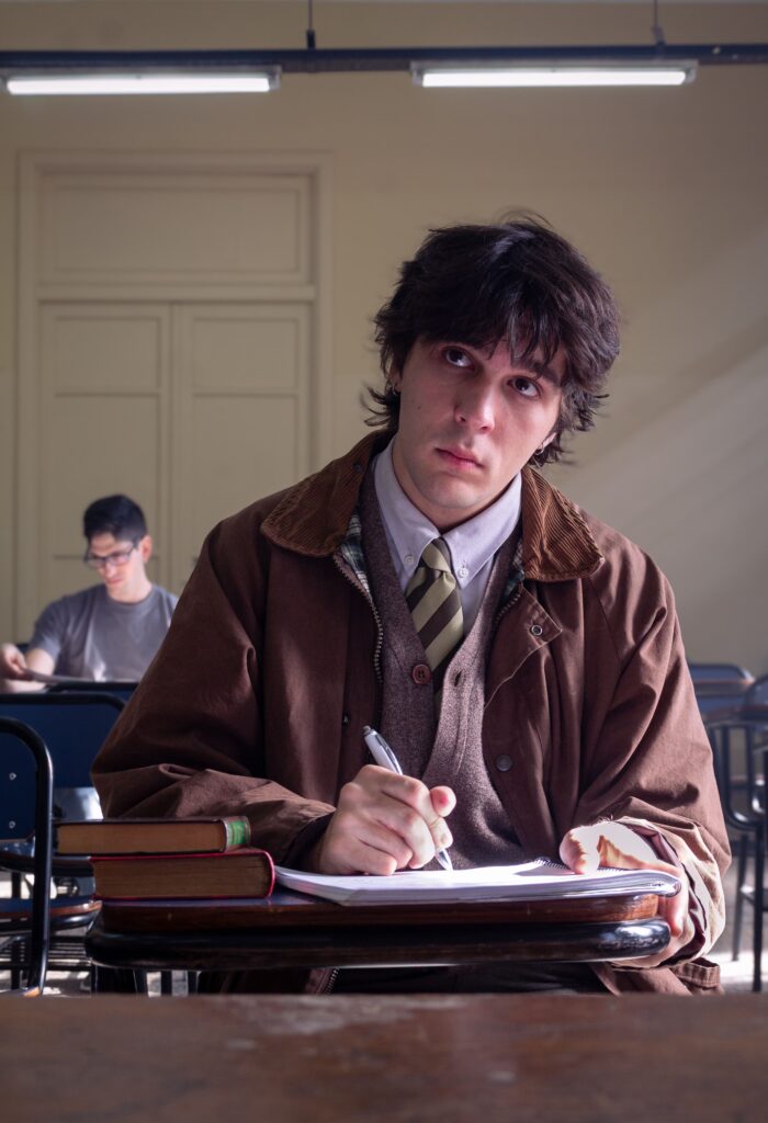 pexels photo 37771139 37771139 Young man with books in a Buenos Aires classroom, focused and studying.